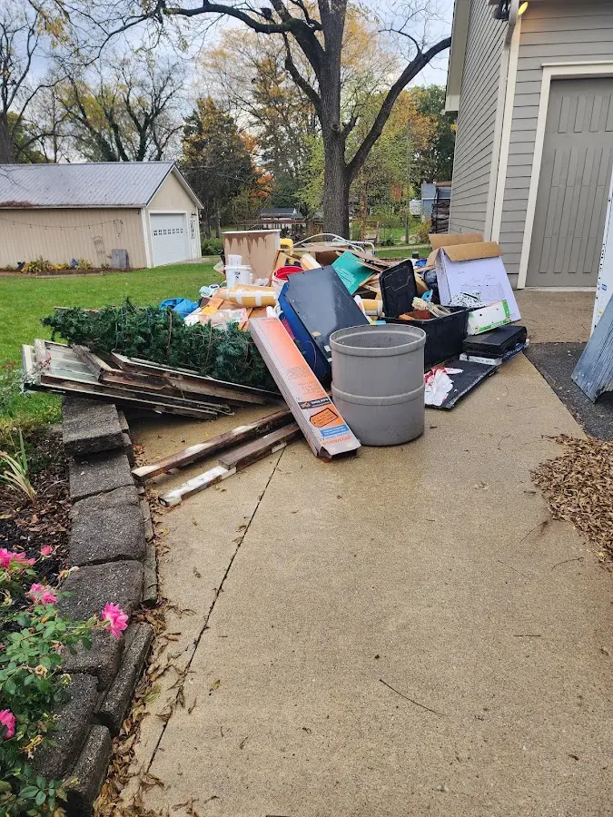 Dumpster being loaded with debris for 3 Yard Dumpster Rental in Forest Park